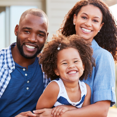 Young family smiling and hugging each other