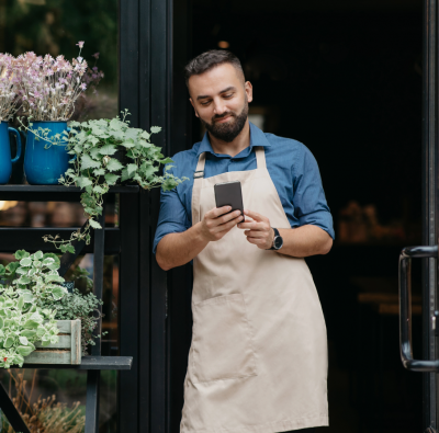 Man at Flower shop looking at phone